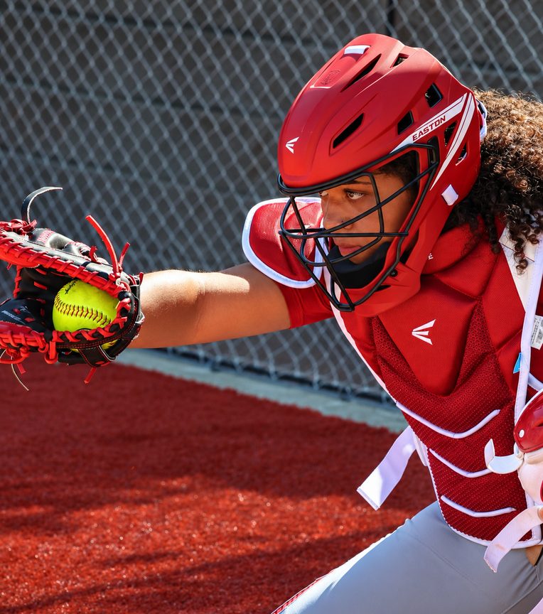 SFS catcher in full gear framing a pitch with her glove